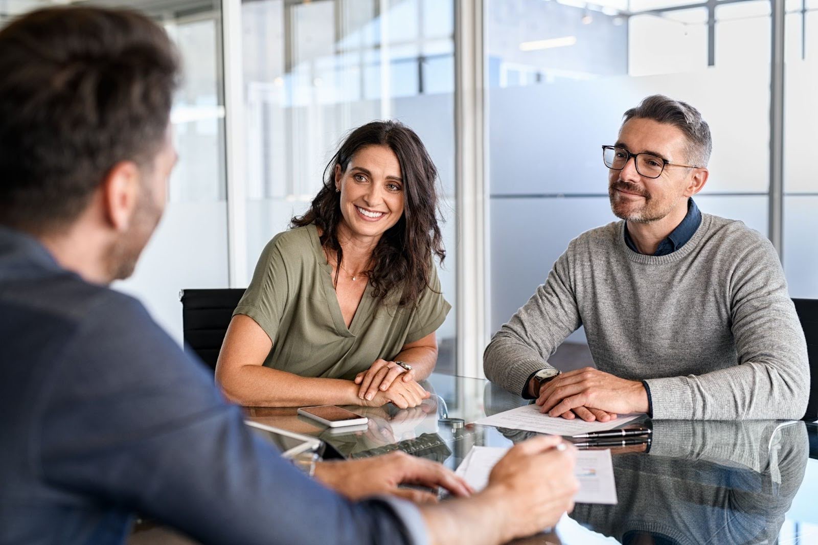 Couple discussing HELOCs and home equity loans with a professional mortgage broker