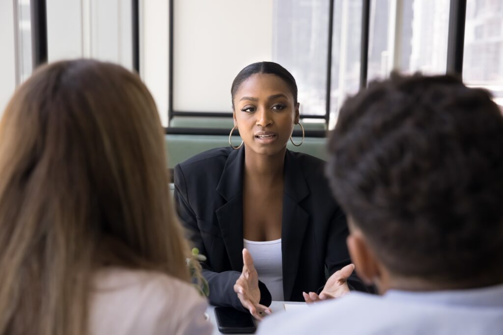 Financial advisor speaking to couple sitting on a couch